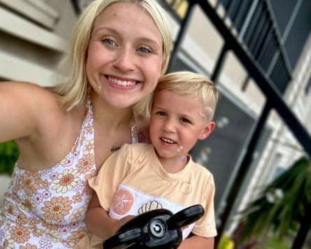 A woman holds a young boy