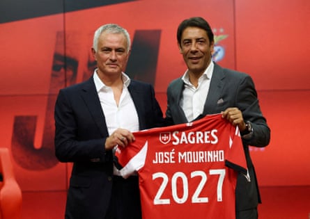 José Mourinho holds up a shirt with Benfica president Rui Costa