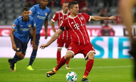 Robert Lewandowski scores Bayern’s third goal from the penalty spot after the referee’s initial decision was overturned by VAR.