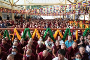 lots of people in red robes sitting in a room