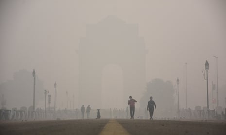 People walk near India Gate, New Delhi, in heavy smog.