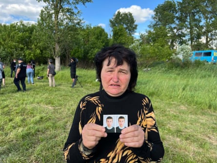 Ivanina, a local Zahaltsy woman, shows photos of her missing nephew Victor.