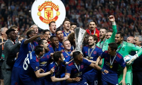Manchester United players celebrate with the Europa League trophy after defeating Ajax 2-0.