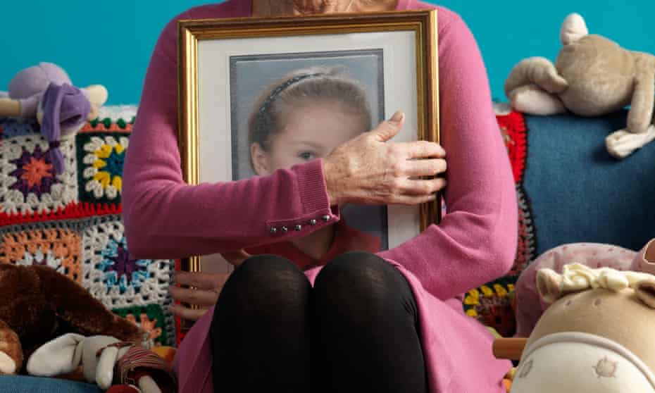 Woman holding picture of child