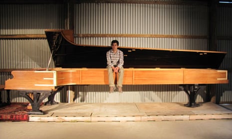 Adrian Mann with his 5.7m-long piano in Dunedin, New Zealand.