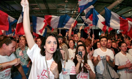 Sarkozy supporters wave flags at 2012 campaign event.