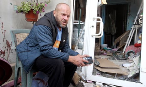 The father of a 31-year-old mother of two, who was killed by a Russian missile, sits by a house destroyed in the attack that took place on Wednesday morning in Obukhivka, Dnipropetrovsk region, central Ukraine.