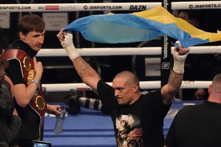 Oleksandr Usyk celebrates with the flag of Ukraine after his unanimous decision victory over Anthony Joshua.