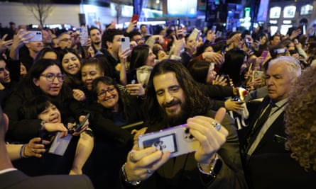 Jonathan Roumie posing for selfies with fans at the premiere of The Chosen: The Last Supper in Madrid, Spain.