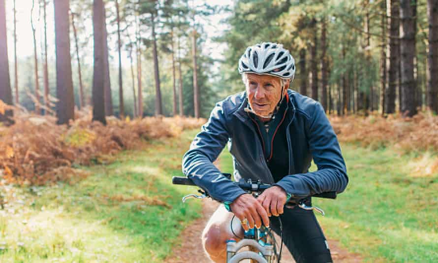senior man on a bike in a forest