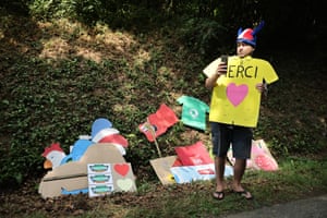A spectator with a plethora of cardboard signs.