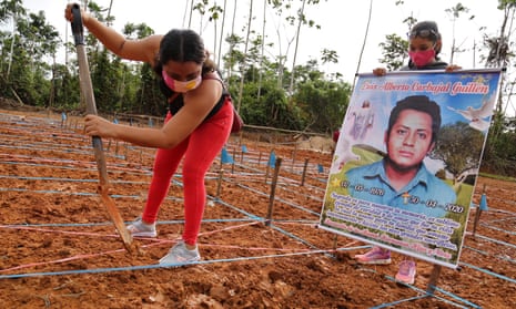 A protester at the site of a common grave for coronavirus victims in Peru demands proper burial for her relative. 