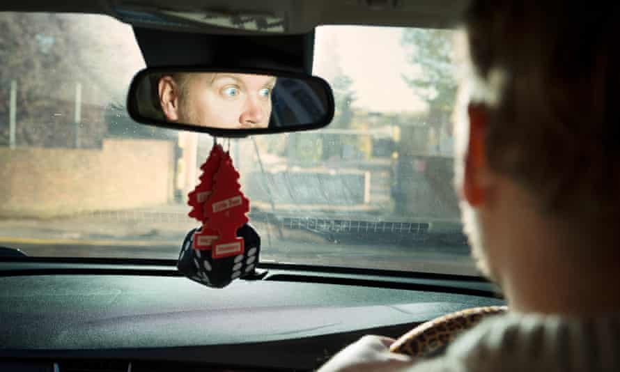 Stuart Heritage looking terrified in the reflection of the rear view mirror and the back of his head, a blurred view through the windscreen of the car he's driving