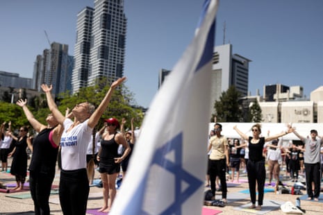 People practise yogain Tel Aviv, as they call for the release of yoga practitioner Carmel Gat among all other hostages kidnapped during the 7 October Hamas attack.