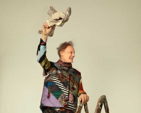 William Orbit standing on a ladder and waving an object