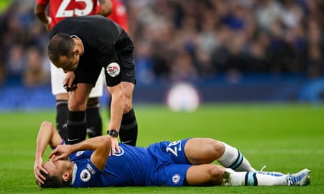 Referee Stuart Attwell checks on Chelsea’s Cesar Azpilicueta after an accidental clash of heads with Jadon Sancho.