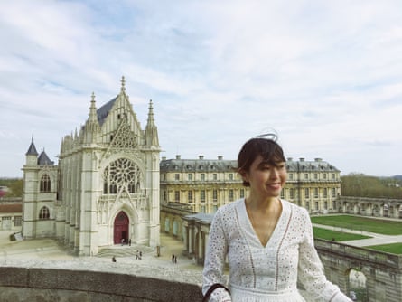 Juhea Kim stands to the right of the chateau.