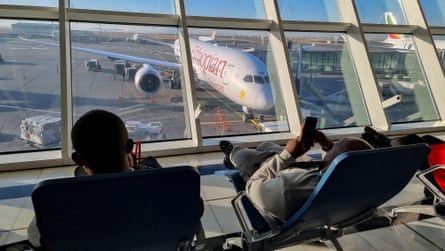 Passengers hold by a model with a airliner parked extracurricular