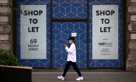 a woman passes a shop for let sign
