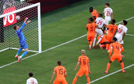 Netherlands keeper Bart Verbruggen reacts well to push the ball over the bar.