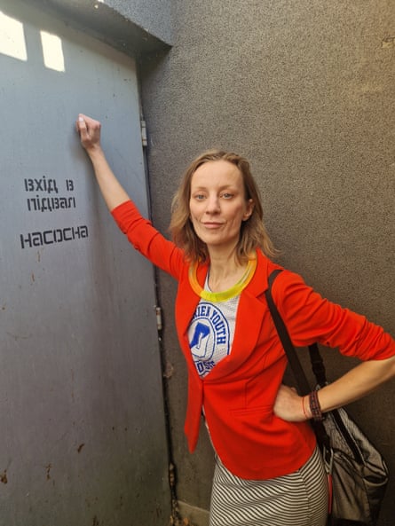 Diana Berg outside a locked shelter door during an air raid in Kyiv.