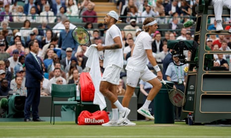 Nick Kyrgios and Stefanos Tsitsipas change ends during their Wimbledon third round match in 2022