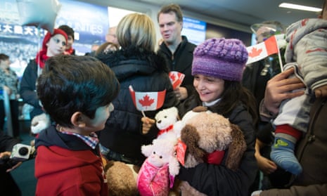 Syrian refugees Rezan Kurdi, left, and his sister Ranim Kurdi laugh after their family arrived at Vancouver international airport in December 2015.