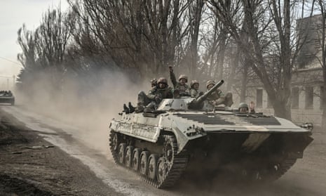 Ukrainian servicemen head toward Bakhmut in an infantry fighting vehicle. The head of Nato has called on the west to continue to supply aid.