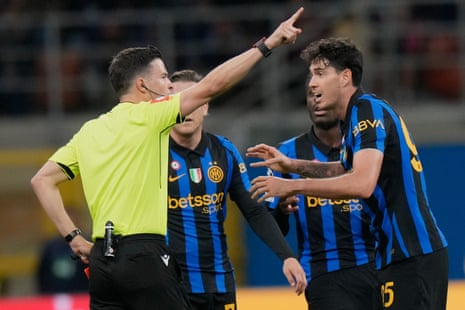 Referee shows Alessandro Bastoni a red card as he reacts with raised hands