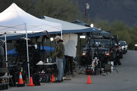 A man stands next to a tent protecting media equipment