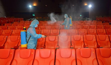 Staff disinfect the seats before reopening a cinema in Kuala Lumpur, Malaysia, at the end of June