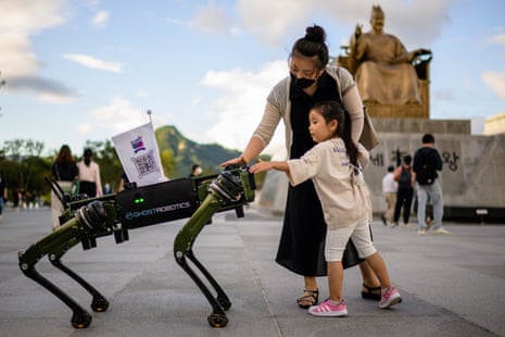 Dogs of war: a young girl and her mother interact with a robot dog, made by Ghost Robotics, in Seoul, South Korea.