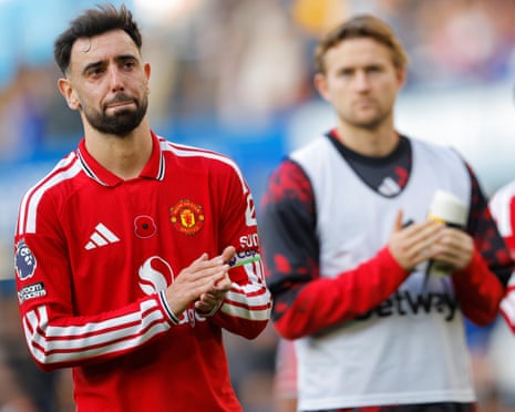Manchester United captain Bruno Fernandes looks dejected as the players applaud the fans after their defeat at Stamford Bridge
