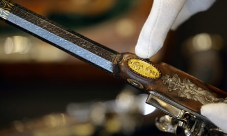 A staff member shows a detail of one of the two pistols, which belonged to Emperor Napoleon I, during the preview before their auction, in Paris on 18 June 2024