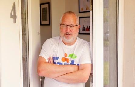 David Brown folds his arms while standing at his door