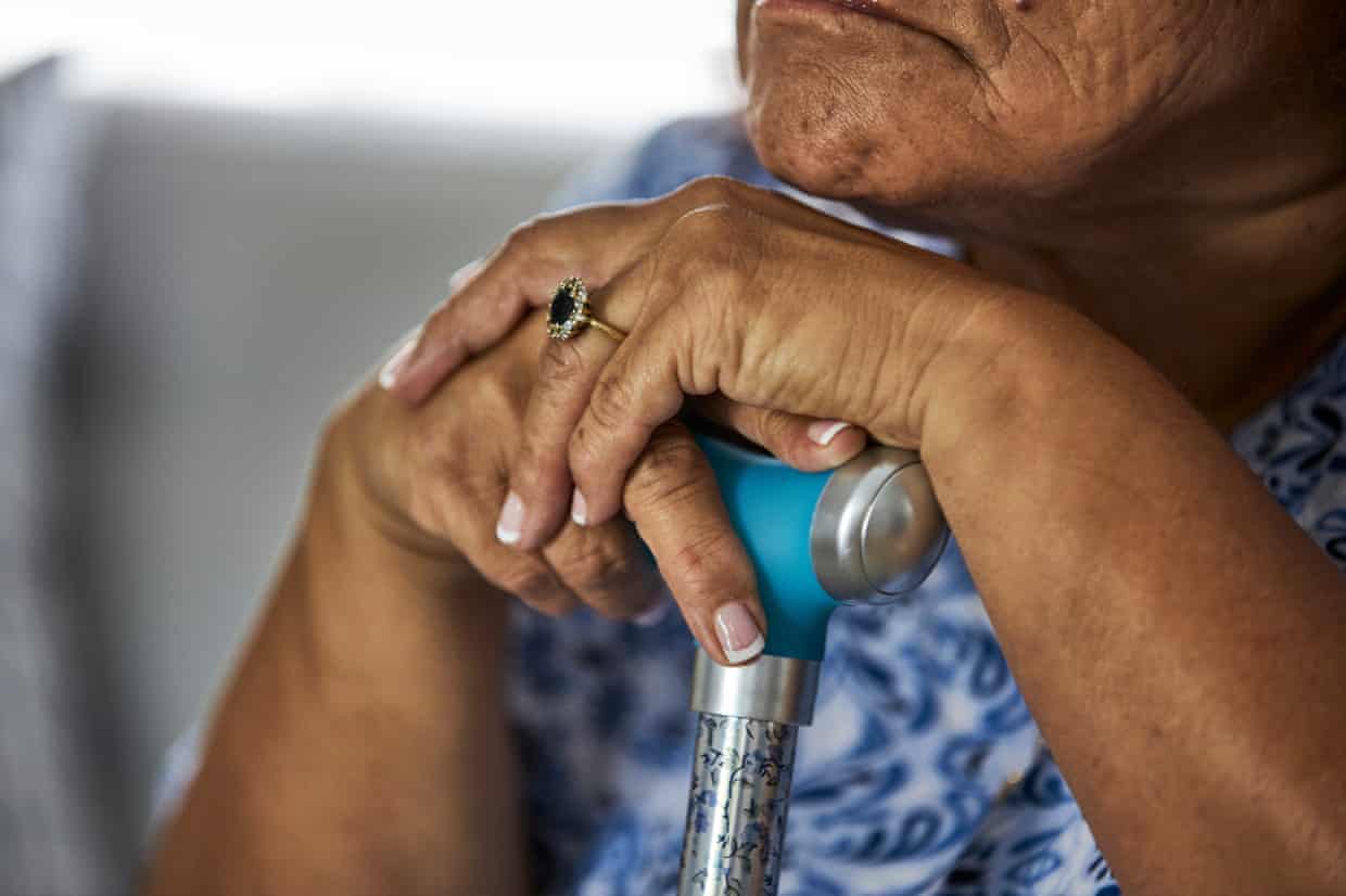 An elderly woman with her walking stick
