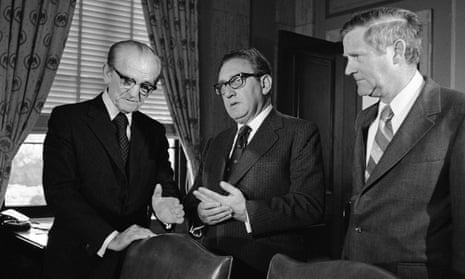 Henry Kissinger chats with Senator John C. Stennis as Linwood Holton, right, an assistant secretary of state for congressional relations, listens in Washington DC in 1974.