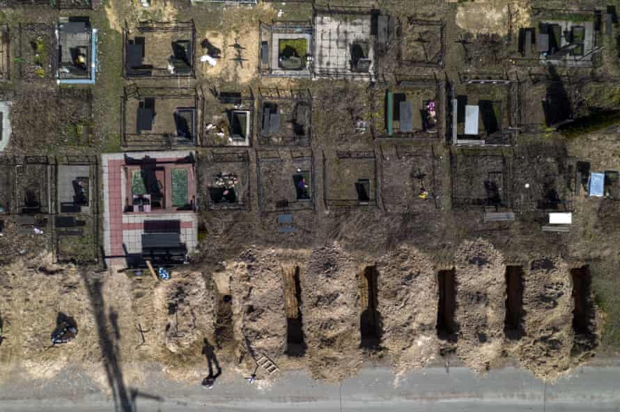 A cemetery worker takes a rest from working on the graves of civilians killed in Bucha on the outskirts of Kyiv.