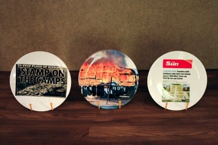 Thee plates, each with anti-Traveller tabloid headlines printed on them.