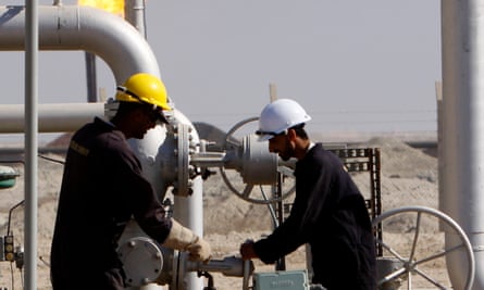 Oil workers work at the West Qurna Phase 2 field in the Basra region.