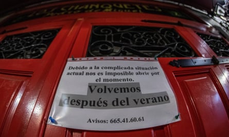 A banner reading ‘we will be back after summer’ hangs from the door of a nightclub in Madrid