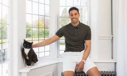 Curtis Davies at home with the family pet cat, Booboo.