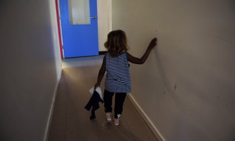 young Aboriginal girl walks down a hall