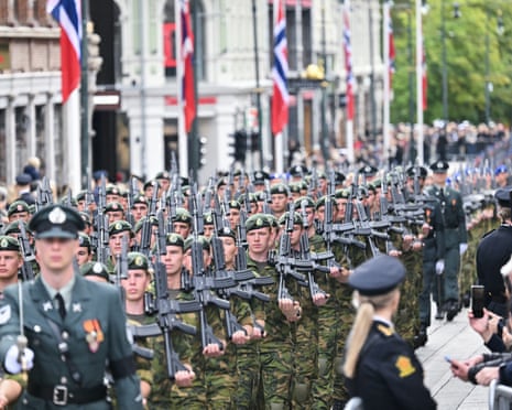 Soldiers parade in the streets and spectators watch before the casket of late King Harald V of Norway is transferred during a royal procession from the Royal Palace Chapel to the Cathedral in Oslo.