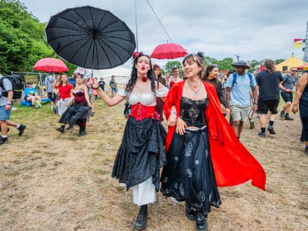 Women in Victorian pirate dress & corsets, and parasols