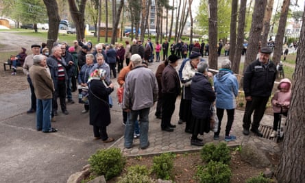 A queue for free bread at a church in Irpin