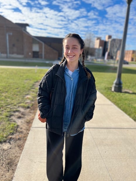 Camille Mikolas, 25, a Physics Student at Michigan State University, smiles as she heads in to vote for Slotkin and yes on prop 3