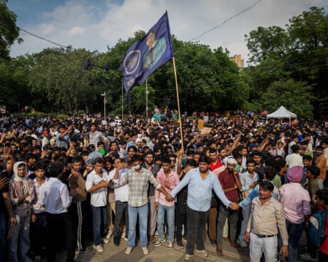 Cockroach supporters link hands in front of a crowd