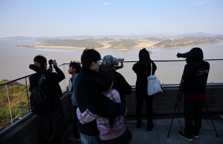 Visitors in Gimpo, South Korea, look toward the North from an observation deck.
