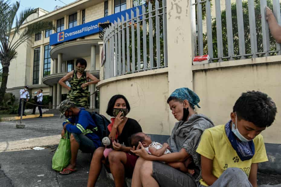 Tisay Adedas tends to a baby at Liwasang Bonifacio whom they rescued from child traffickers. Illegal adoption of newborn babies from very poor families is widespread